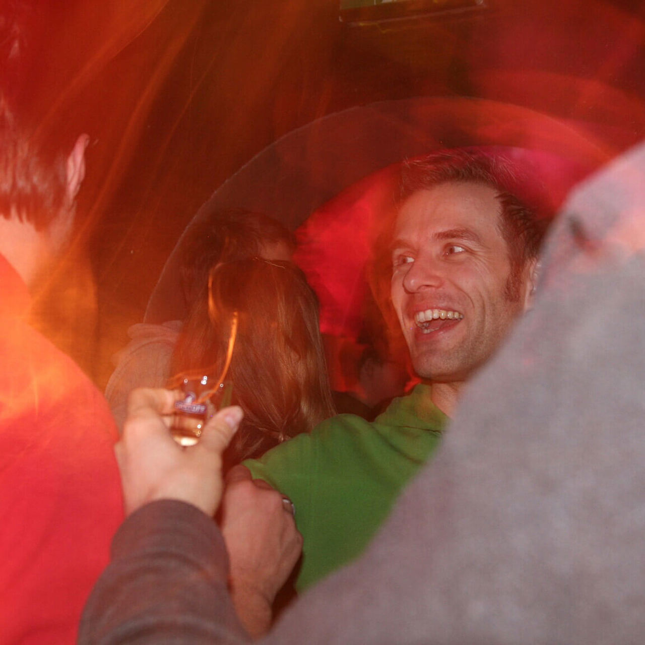 A happy Keen employee surrounding by others at a party